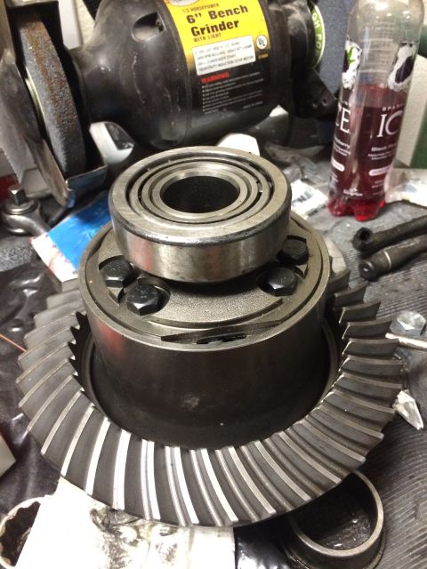 1996 Ford Bronco - Differential gear and bearing assembly shown with a bench grinder and drink bottle.