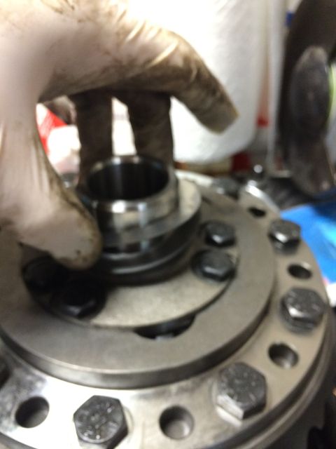 1996 Ford Bronco - A mechanic works on a differential carrier assembly, a key component of a vehicle's drivetrain.