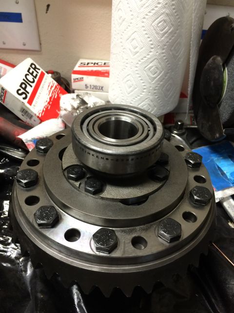 1996 Ford Bronco - A differential carrier assembly with a bearing and bolts is shown, with Spicer parts boxes and paper towels visible.
