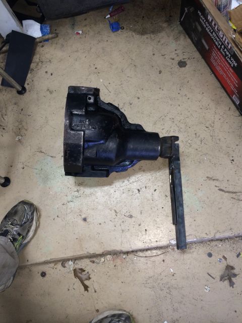 1996 Ford Bronco - A black metal vise with a handle is shown on a concrete floor, with a box for a vise in the background.