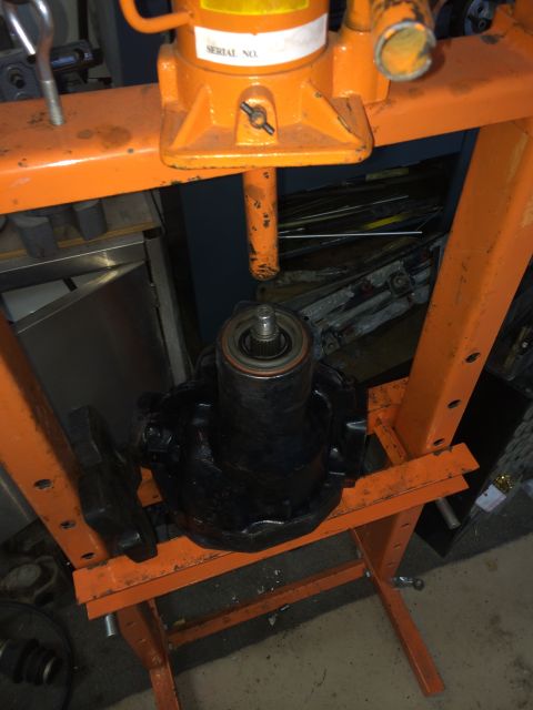 1996 Ford Bronco - Automotive part being worked on in a hydraulic press. Serial number visible on the press.