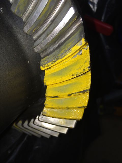 1996 Ford Bronco - A close-up view of a differential gear, showing its teeth and yellow markings.