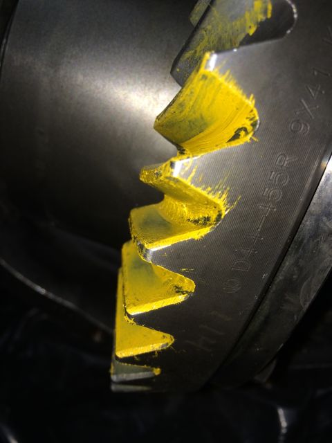 1996 Ford Bronco - Close-up of a differential gear with yellow paint applied to its teeth and visible part numbers.