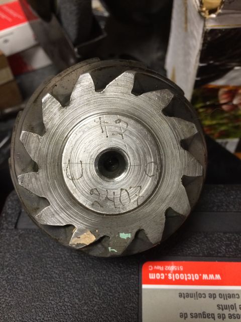 1996 Ford Bronco - A close-up view of a metal gear with visible teeth and handwritten markings indicating a part number.