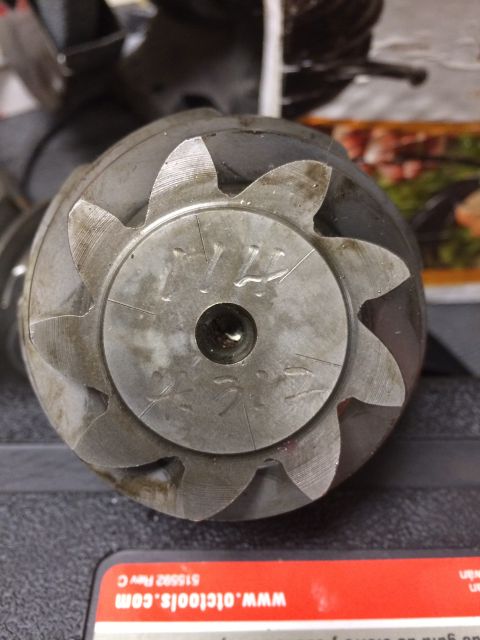 1996 Ford Bronco - A close-up view of a metal gear part, showing its teeth and some etched markings on its surface.