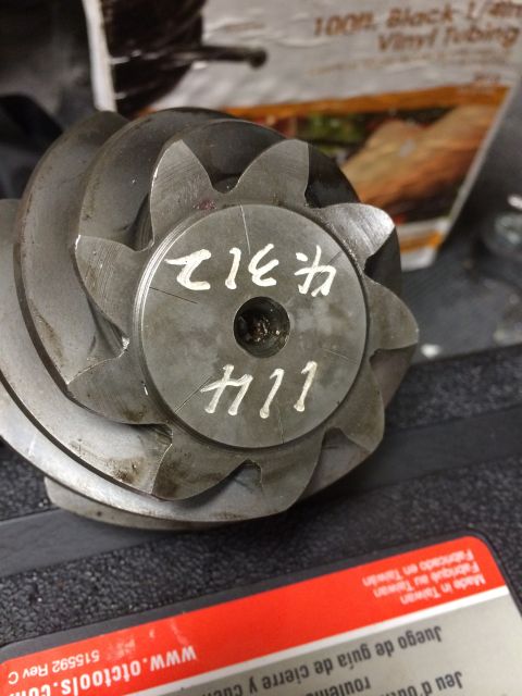 1996 Ford Bronco - A close-up view of a metal gear component with handwritten numbers.