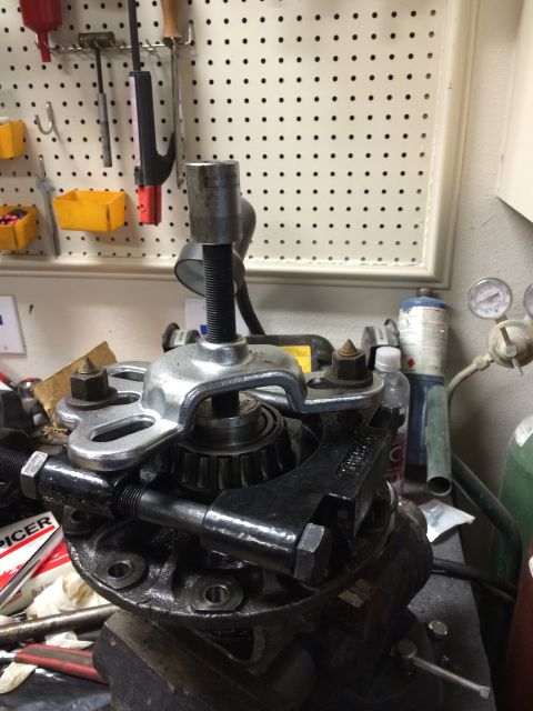 1996 Ford Bronco - A bearing puller is used on a differential housing, with 'SPICER' visible on a box in the background.