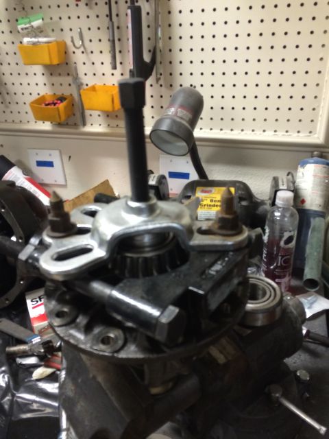 1996 Ford Bronco - Close-up of a differential gear assembly being worked on, with tools and bearings.