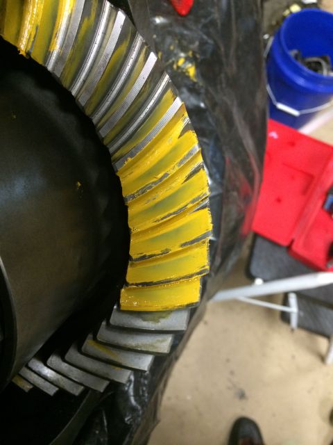 1996 Ford Bronco - Close-up of a differential ring gear showing yellow marking compound on its teeth.