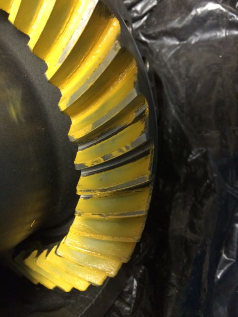 1996 Ford Bronco - A close-up view of a differential gear, showing yellow markings on its teeth.