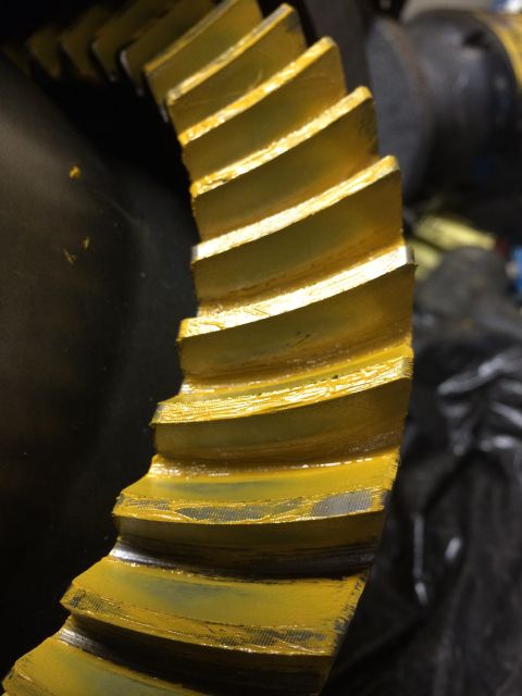 1996 Ford Bronco - Differential ring gear with yellow coating and visible teeth.