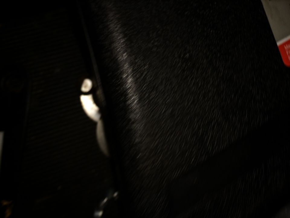 Black textured interior panel with a silver latch mechanism visible