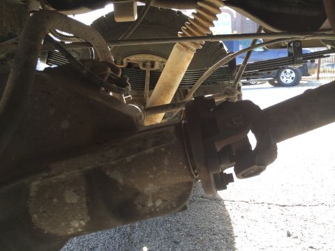 1996 Ford Bronco - Close-up view of the rear axle, leaf springs, and driveshaft U-joint.