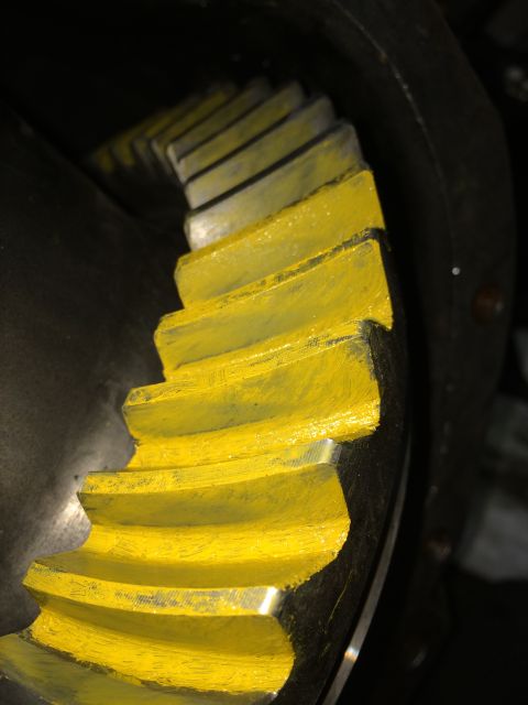 1996 Ford Bronco - A close-up shows a differential gear with yellow painted teeth, indicating a specific component within a vehicle's drivetrain.