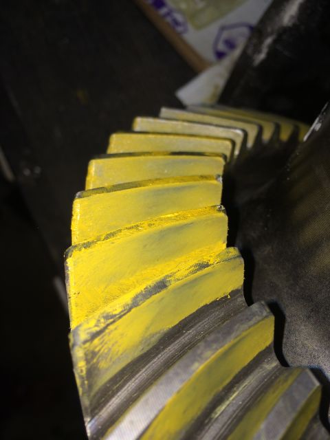 1996 Ford Bronco - Differential gear teeth, painted yellow, are shown in a close-up view.