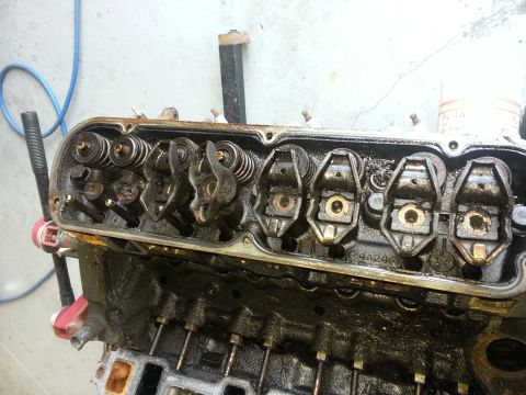 1994 Ford Bronco - Close-up view of an engine's cylinder head, showing internal components like rocker arms and valves.