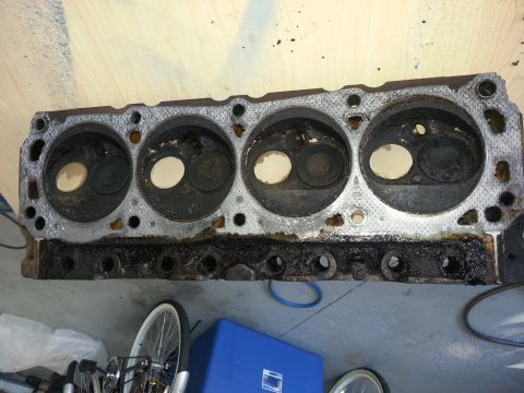 1994 Ford Bronco - This engine cylinder head shows signs of wear and tear, with carbon buildup around the valves.
