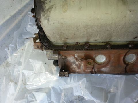 1994 Ford Bronco - Close-up of an engine oil pan, showing its bolted construction and gasket seal.