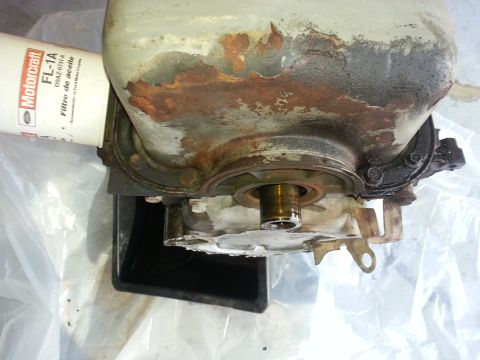 1994 Ford Bronco - A Motorcraft FL-1A oil filter is attached to a heavily corroded engine part.