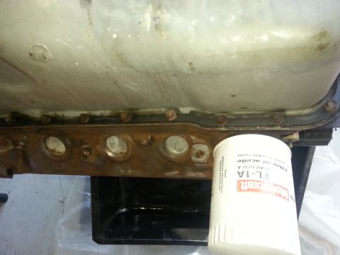 1994 Ford Bronco - A Motorcraft FL-1A oil filter is shown next to a vehicle's oil pan.