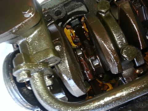 1994 Ford Bronco - Close-up view of internal engine components, including the crankshaft and connecting rods, coated in oil.