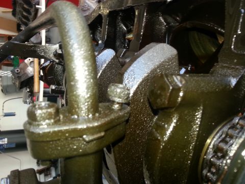 1994 Ford Bronco - Engine oil pump assembly components covered in oil.