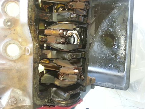 1994 Ford Bronco - Close-up view of an engine's internal components, showing the crankshaft and connecting rods.