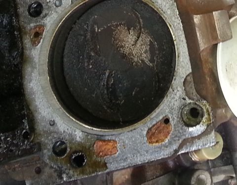 1994 Ford Bronco - Close-up view of an engine cylinder, revealing the piston and signs of wear and carbon deposits.