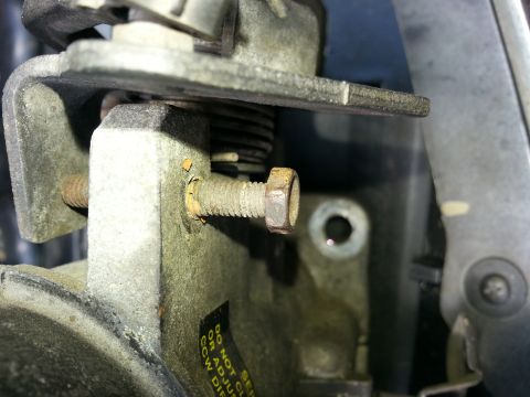 1994 Ford Bronco - Close-up view of a throttle body component, showing mechanical details and warning text.