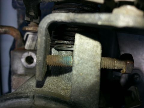1994 Ford Bronco - This image shows a close-up view of mechanical components, likely part of a throttle body assembly, with visible rust on a bolt.