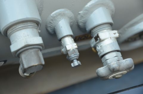 1979 Ford Bronco - Three silver propane tank valves are shown in close-up detail.
