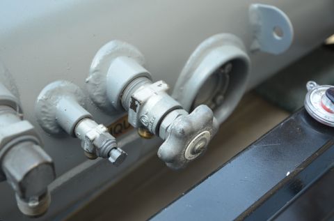1979 Ford Bronco - Propane tank valves and gauge visible on a vehicle component.