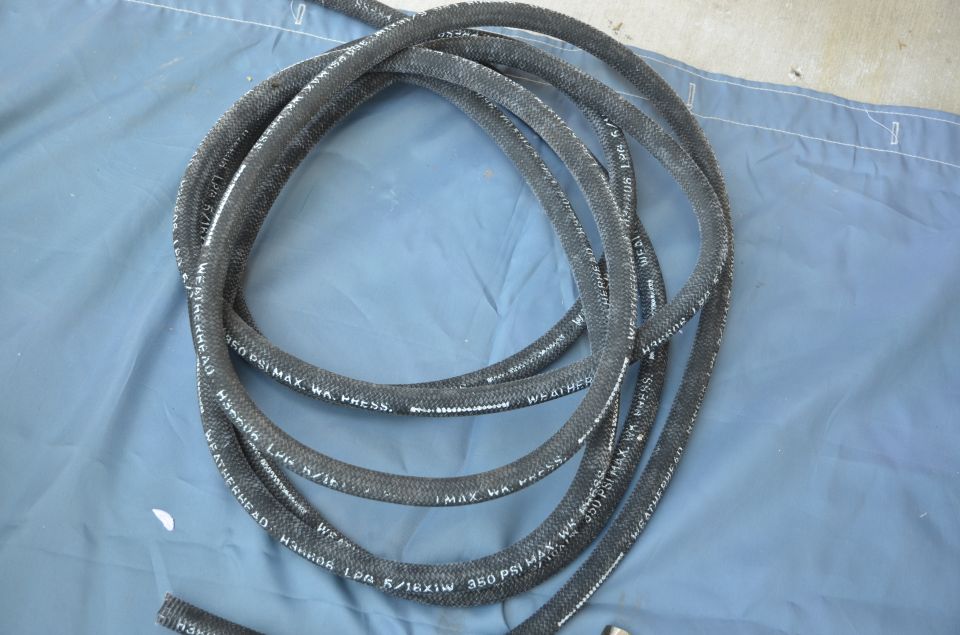 Black braided hose with white text reading "WEATHERHEAD 350 PSI MAX. WA. PRESS."