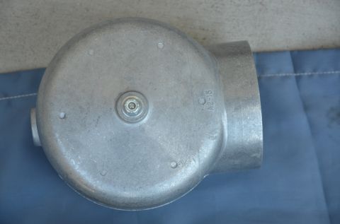 1979 Ford Bronco - A close-up view of a metal component with pipe connections, marked with 'C A2-15'.