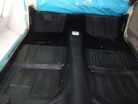 1967 Ford Mustang - The interior floor of a vehicle is shown after being cleaned and coated.