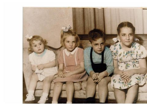 1998 Ford Crown Victoria - A group of four children pose for a photograph while sitting together on a couch.