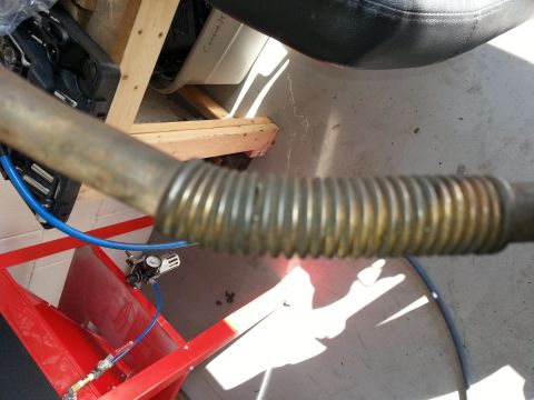 1994 Ford Bronco - Close-up of a flexible exhaust pipe section, likely part of a vehicle repair project.
