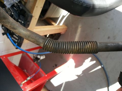 1994 Ford Bronco - Close-up of a corrugated metal pipe, possibly part of an exhaust system.