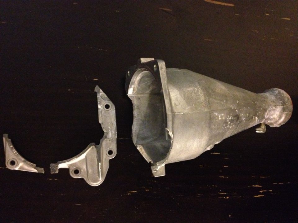 Broken metal exhaust part on dark surface