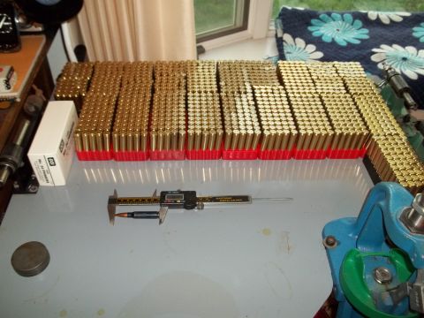 1972 Ford Ranchero - A large quantity of ammunition is organized and measured with a caliper, alongside reloading equipment.