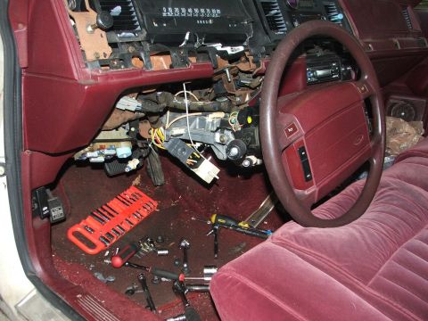 1991 Ford Crown Victoria LTD - The interior of a 1991 Ford Crown Victoria LTD shows a disassembled dashboard with tools and wiring exposed.