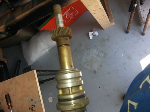 1994 Ford Bronco - Close-up view of a distributor shaft with a gear and several rings, likely a vehicle part.
