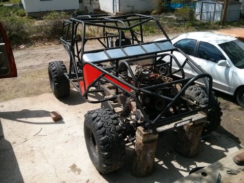 1986 Ford Bronco - Custom off-road buggy chassis under construction, with a white sedan parked nearby.
