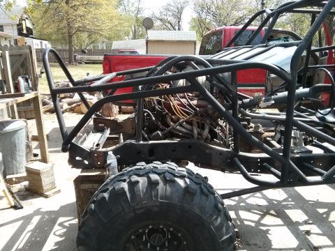 1986 Ford Bronco - This vehicle is undergoing a custom build, with a roll cage and exposed engine components visible.