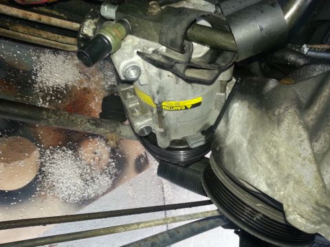 1994 Ford Bronco - Close-up view of an air conditioning compressor, likely from a vehicle's engine bay.