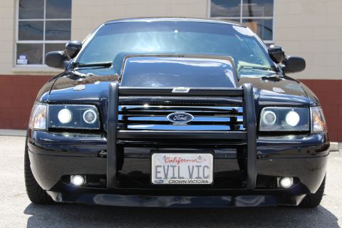2003 Ford Crown Victoria - Tight head-on shot of a black Ford Crown Victoria with halo projector headlights, Ford grille guard and a California EVIL VIC plate.