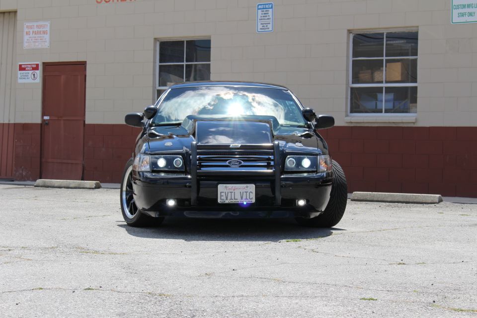 Front view of black Ford Crown Victoria with Ford grille guard and EVIL VIC plate