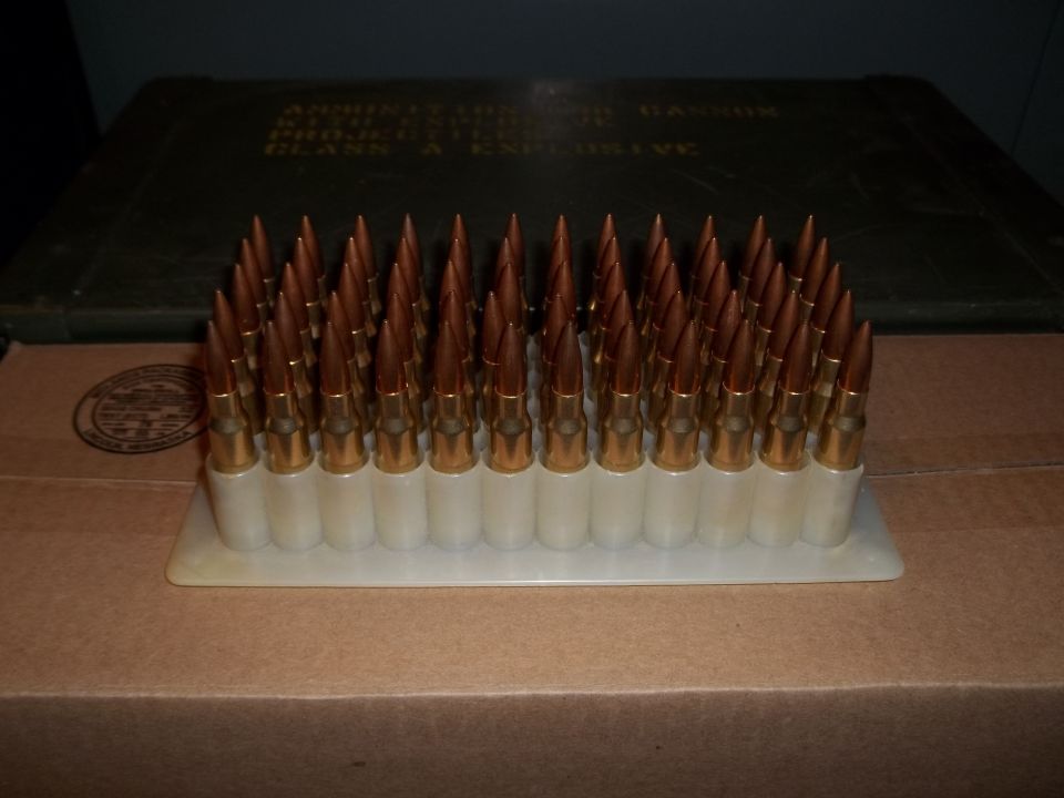 Tray of rifle cartridges in front of an ammo can