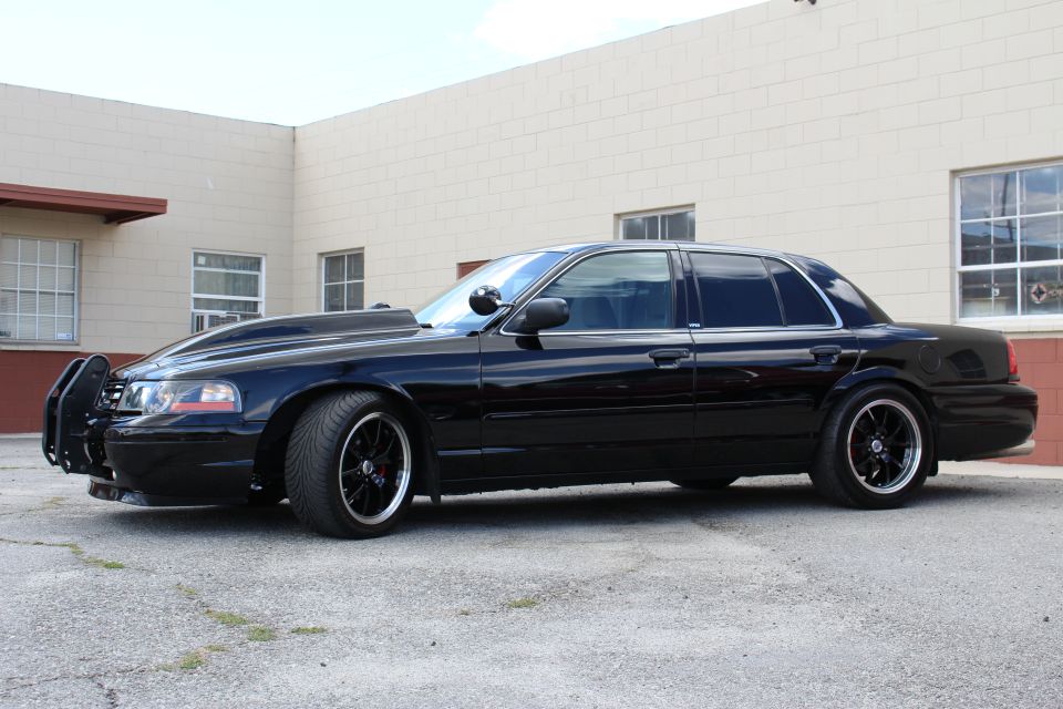 Black Ford Crown Victoria side profile, push bar, black wheels