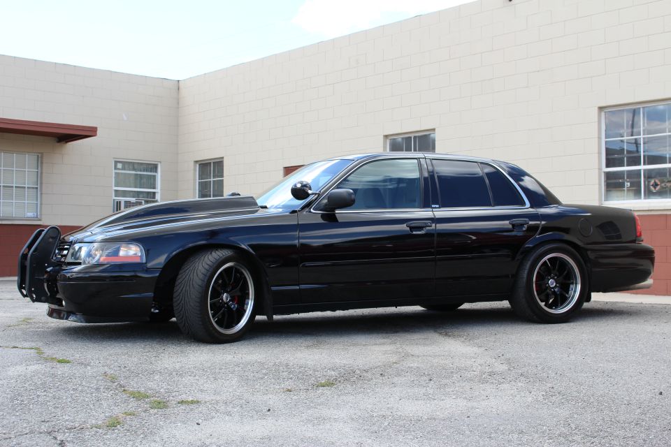 Black Ford Crown Victoria side profile, lowered with push bar
